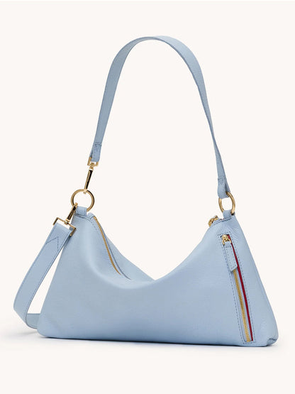 The Hammitt Los Angeles Kyle Medium Shoulder Bag in Hazy Blue/Gold features pebbled leather, gold hardware, an adjustable strap, and zipper accents on the front and top for a stylish look.