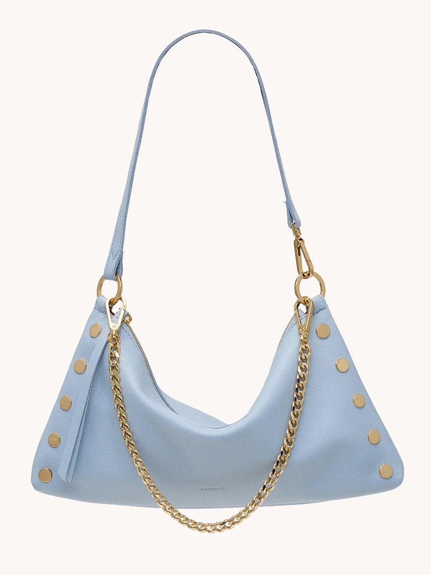 The Hammitt Los Angeles Kyle Medium Shoulder Bag in Hazy Blue/Gold features pebbled leather, gold studs, a detachable gold chain, and an adjustable shoulder strap, displayed against a plain background.