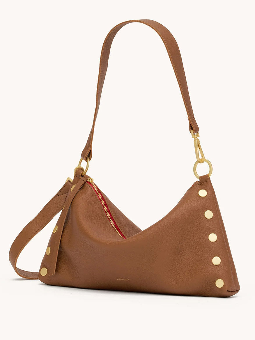 The Hammitt Los Angeles Kyle Medium Shoulder Bag in Mahogany Pebble/Brushed Gold & Red Zip features gold side studs, a striking red zipper detail, and an adjustable strap. Shown as a stylish crossbody on a plain background.