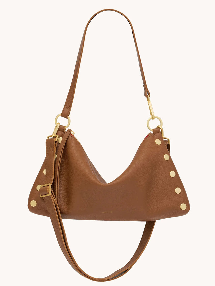 The Hammitt Los Angeles Kyle Medium Shoulder Bag in Mahogany Pebble with brushed gold hardware and red zip features decorative gold studs on the side and an adjustable shoulder strap.