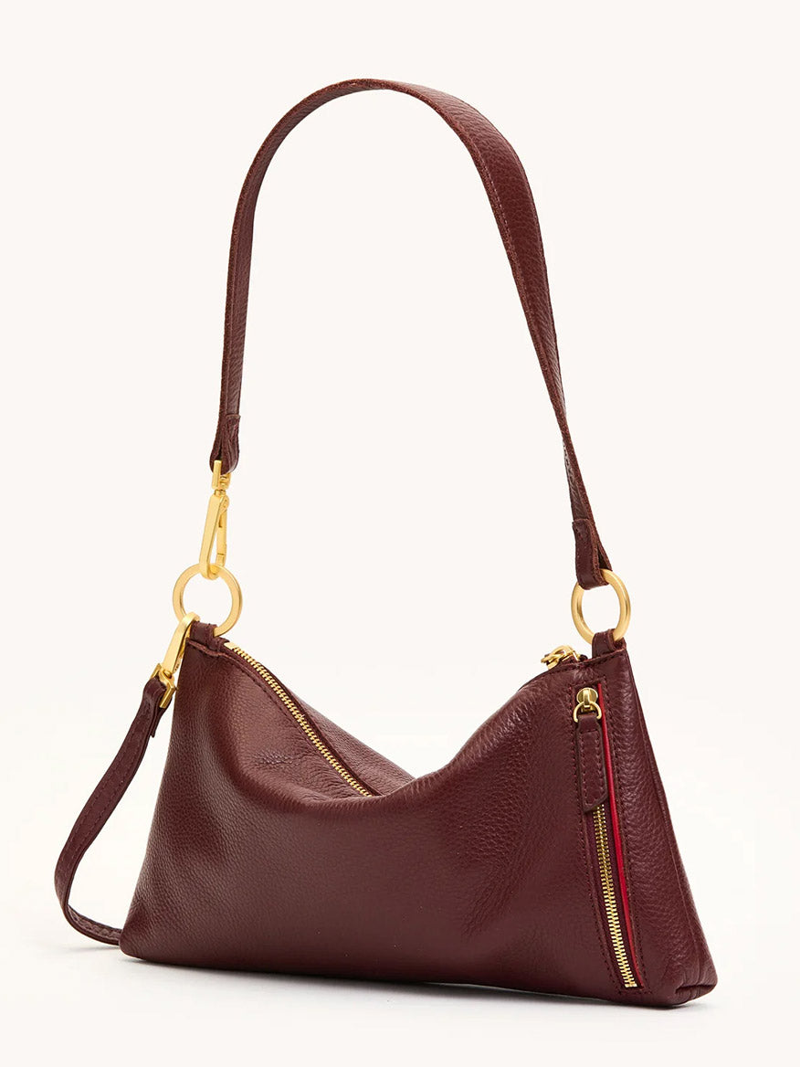 The Hammitt Los Angeles Kyle Shoulder Bag in Cherrywood Pebble features brushed gold hardware, a single shoulder strap, and visible top and side zippers.