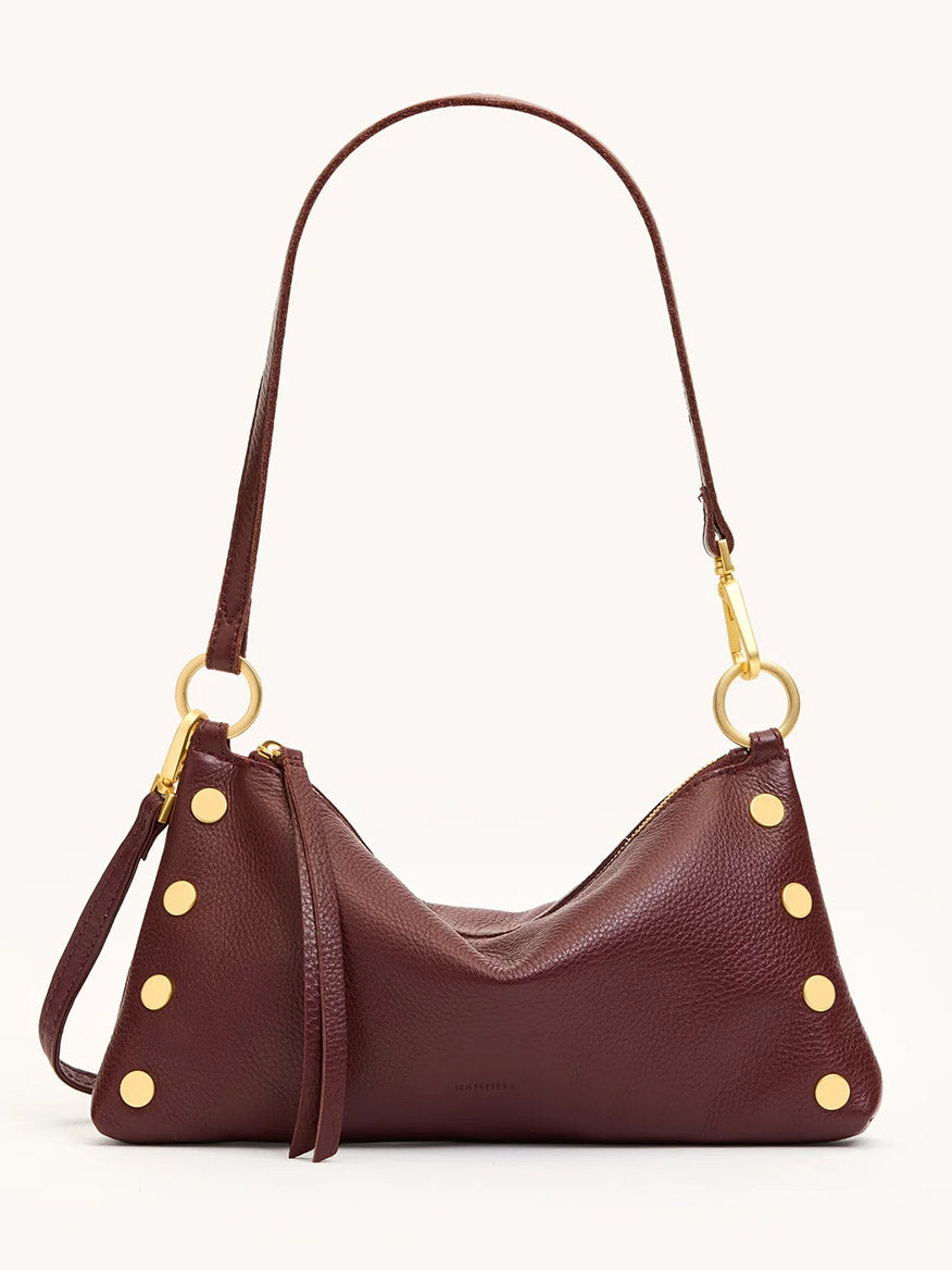 The Hammitt Los Angeles Kyle Shoulder Bag in Cherrywood Pebble/Brushed Gold features gold studs, a detachable strap for crossbody wear, and gold hardware, shown against a plain light background.