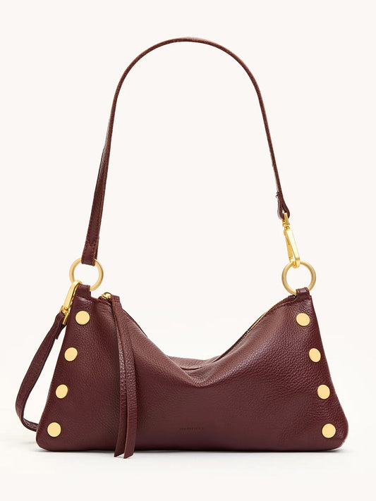 The Hammitt Los Angeles Kyle Shoulder Bag in Cherrywood Pebble/Brushed Gold features gold studs, a detachable strap for crossbody wear, and gold hardware, shown against a plain light background.