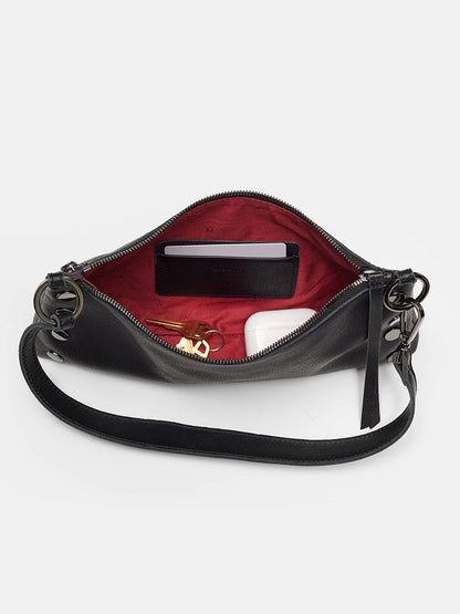 The Hammitt Los Angeles Kyle Shoulder Bag in Black boasts a pebbled leather exterior and a vibrant red interior. Inside, you'll find space for essentials like a white item, a set of keys, and a small wallet. This adaptable bag also includes an adjustable crossbody strap for your ultimate convenience.