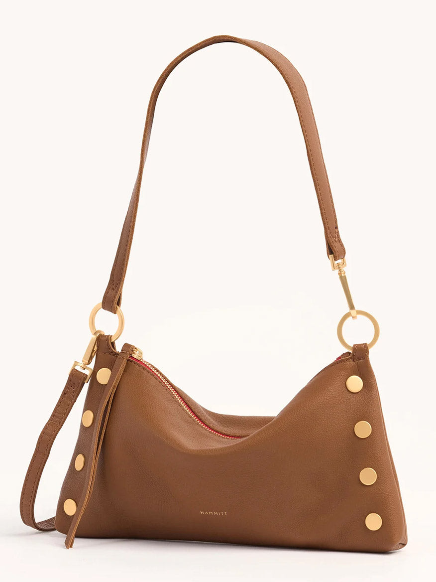 The Hammitt Los Angeles Kyle Shoulder Bag features mahogany pebbled leather, gold studs and hardware, a red zipper, and an adjustable strap.