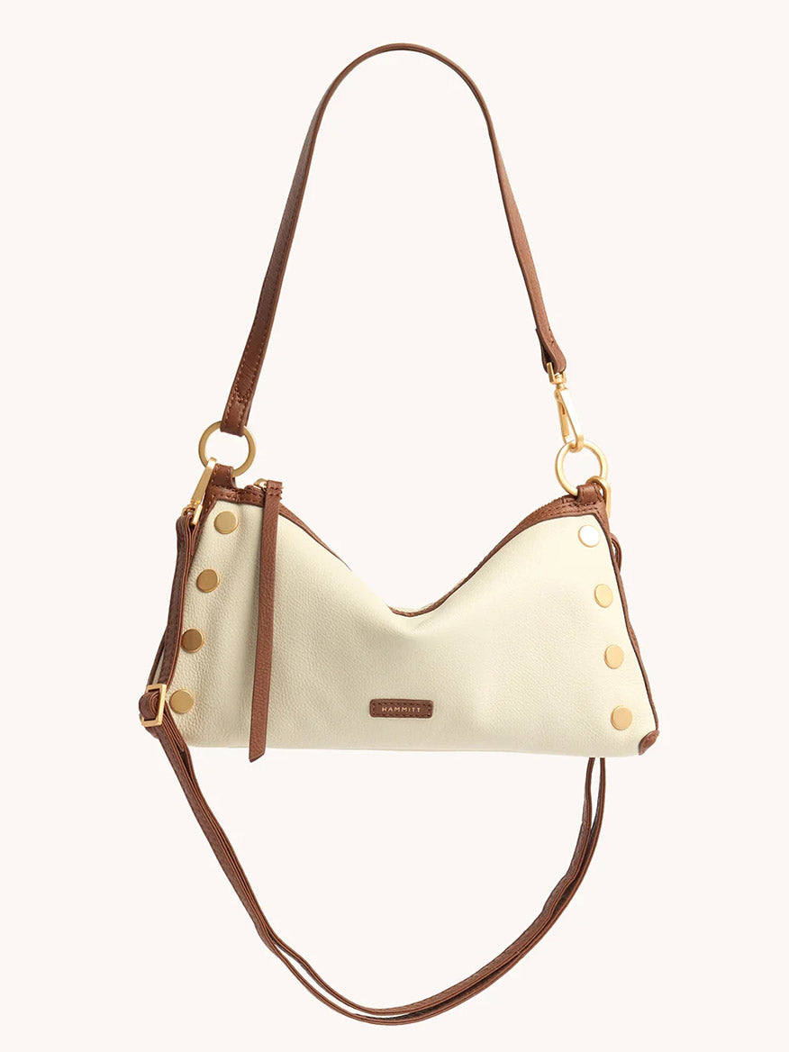 The Hammitt Los Angeles Kyle Shoulder Bag in Courtyard Cream is a cream crescent handbag made of pebbled leather, featuring brown adjustable straps, gold-tone hardware, and decorative side studs.