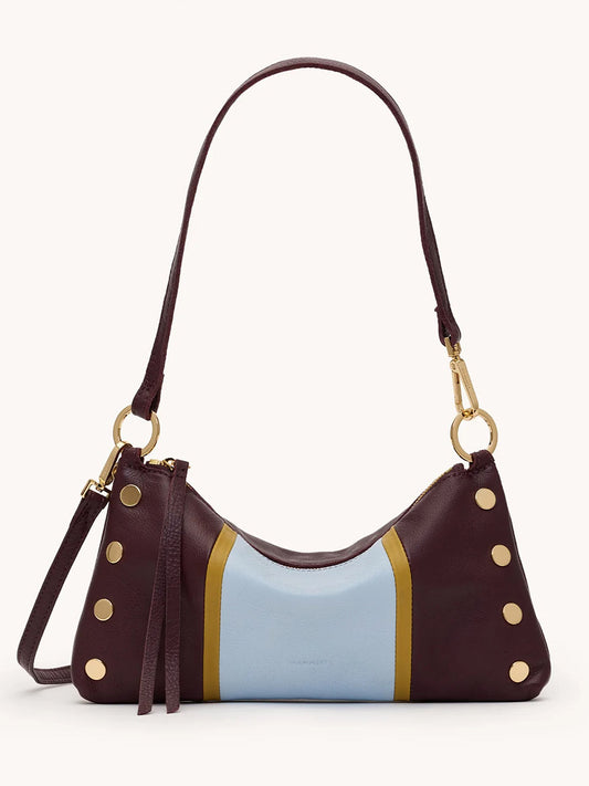 The Hammitt Los Angeles Kyle Shoulder Bag in Regatta Stripe/Gold showcases a curved, two-tone design with burgundy sides, a light blue center panel, gold studs, and a detachable matching shoulder strap.