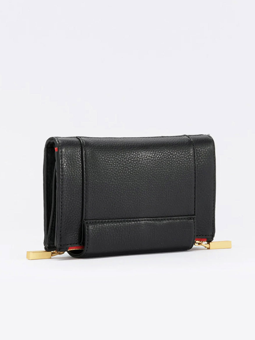 A Hammitt Los Angeles Levy Clutch in Black w/Red Zip with a textured surface, featuring gold metal accents at each end and sophisticated organizational elements for your essentials.