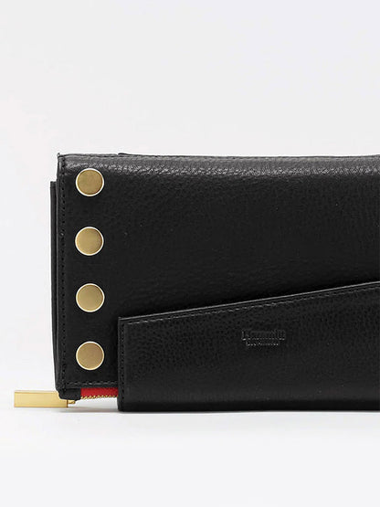 A Hammitt Los Angeles Levy Clutch in Black w/Red Zip with gold button accents, a zippered section, and thoughtful organizational elements.