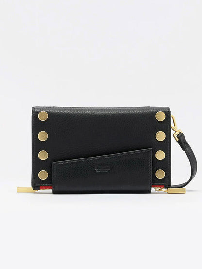 A Hammitt Los Angeles Levy Clutch in Black w/Red Zip with gold circular studs along the sides, featuring a removable adjustable strap and zipper detail at the bottom, complete with organizational elements to keep your essentials in order.