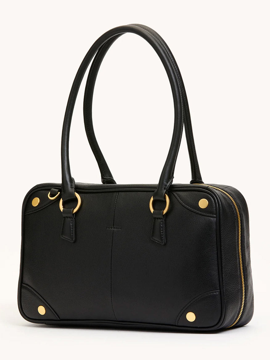 The Hammitt Los Angeles Meredith Medium in Black/Brushed Gold is a rectangular doctor-style bowling bag crafted from black pebble leather, featuring two handles, brushed gold hardware, and a side zipper, shown against a plain background.