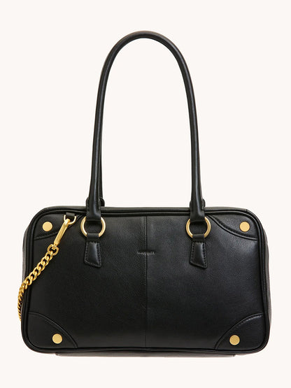 The Hammitt Los Angeles Meredith Medium in Black/Brushed Gold is a doctor-style bowling bag with black pebble leather, brushed gold hardware, two handles, a front pocket, and a gold chain detail on one side.