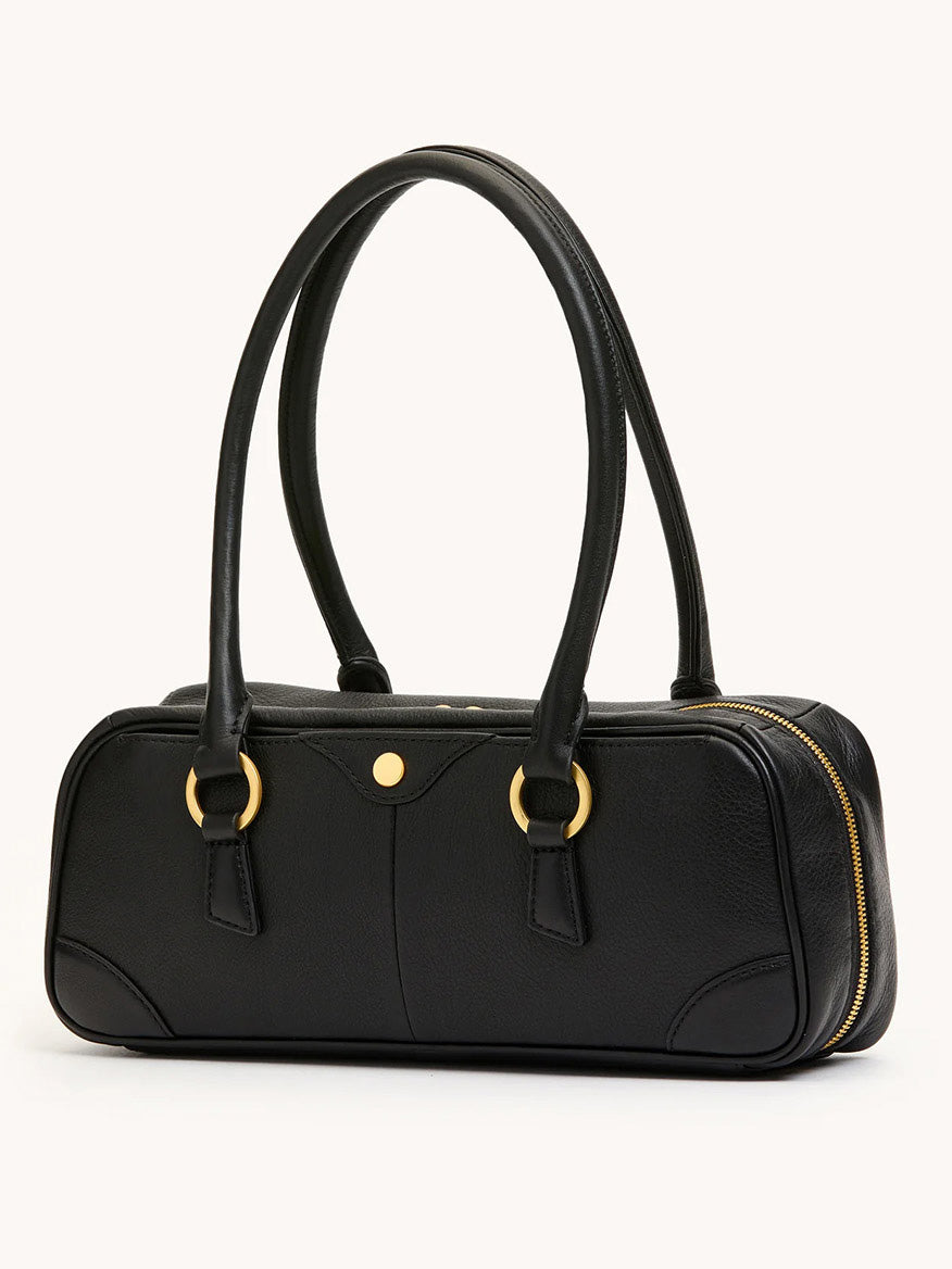 The Hammitt Los Angeles Meredith Small in Black/Brushed Gold, featuring pebbled leather, gold ring accents, double handles, and a side zipper, showcases a doctor-style bowling bag silhouette against a plain light background.