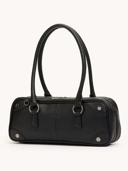 The Hammitt Los Angeles Meredith Small in Black/Gunmetal is a structured cylindrical crossbody handbag in black pebble leather with two handles and gunmetal ring and rivet details, shown against a neutral background.