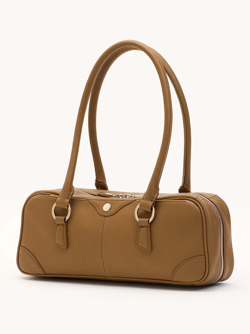 The Hammitt Los Angeles Meredith Small in Dune/Silver is a tan leather bowling bag with two long handles, silver hardware, a rectangular shape, and a zippered closure, shown against a plain light background.