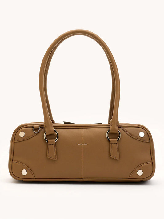 The Hammitt Los Angeles Meredith Small in Dune/Silver is a rectangular tan leather bowling bag with double handles, silver hardware, and subtle stitching details, shown against a neutral background.