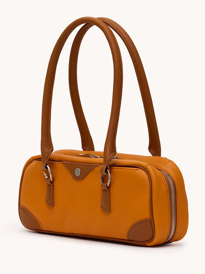 The Hammitt Los Angeles Meredith Small in Tailored Tangerine/Silver is a rectangular orange pebbled leather handbag with brown leather handles, silver accents, a side zip closure, and minimal hardware.