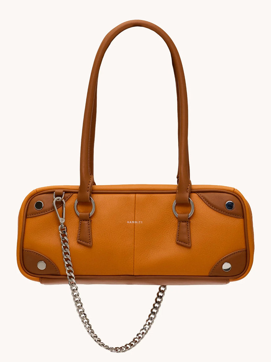 The Hammitt Los Angeles Meredith Small in Tailored Tangerine/Silver is a rectangular orange pebbled leather handbag with dual brown handles, silver chain strap, metal rivet accents, and a small gold logo inspired by the classic bowling bag.