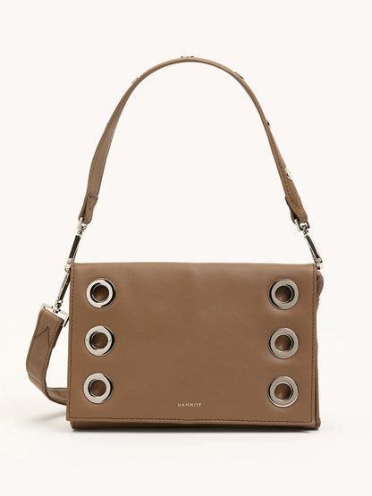 The Hammitt Los Angeles Montana Clutch Sml in Dune/Silver is a vintage-inspired brown leather handbag with a short strap and six large silver grommets on the front flap—ideal as a classic clutch accessory.