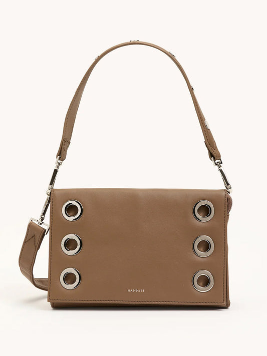 The Hammitt Los Angeles Montana Clutch Sml in Dune/Silver is a vintage-inspired brown leather handbag with a short strap and six large silver grommets on the front flap—ideal as a classic clutch accessory.