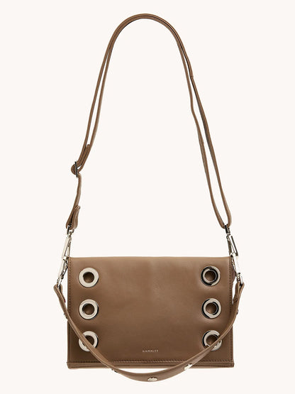 The Hammitt Los Angeles Montana Clutch Sml in Dune/Silver is a vintage-style brown leather crossbody bag with silver grommet details and an adjustable strap, shown against a plain light background.