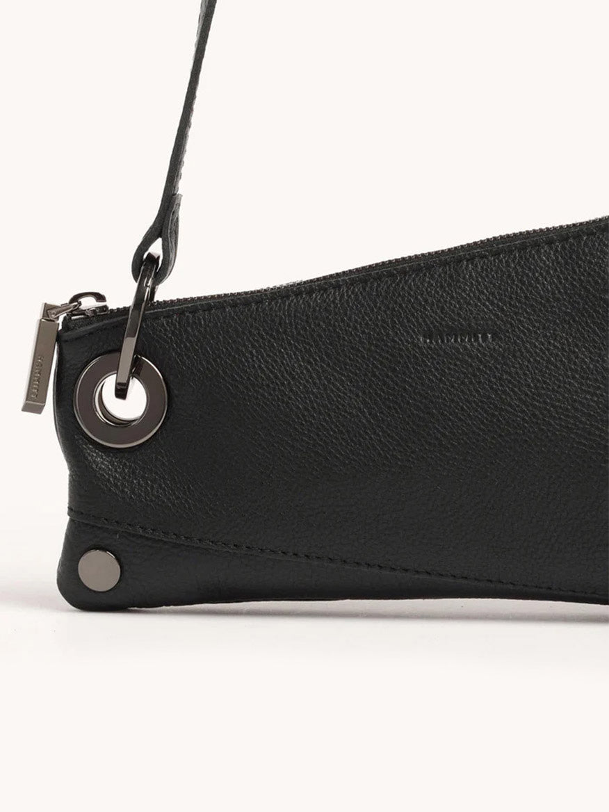 Close-up of a Hammitt Los Angeles Nash Pochette in Black/Gunmetal, featuring sleek metal grommets and a zipper.