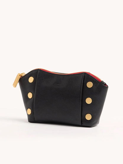 The Hammitt Los Angeles Paul Pocket in Black Press/Brushed Gold is a mini evening clutch in Italian calf leather, featuring gold-tone button accents, a red zipper, and a gold zipper pull against a sleek black background.