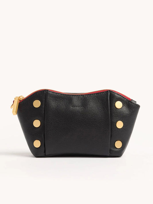The Hammitt Los Angeles Paul Pocket in Black Press/Brushed Gold is a black Italian calf leather mini evening clutch with a red zipper, brushed gold zipper pull, and gold circular studs arranged vertically on both sides.