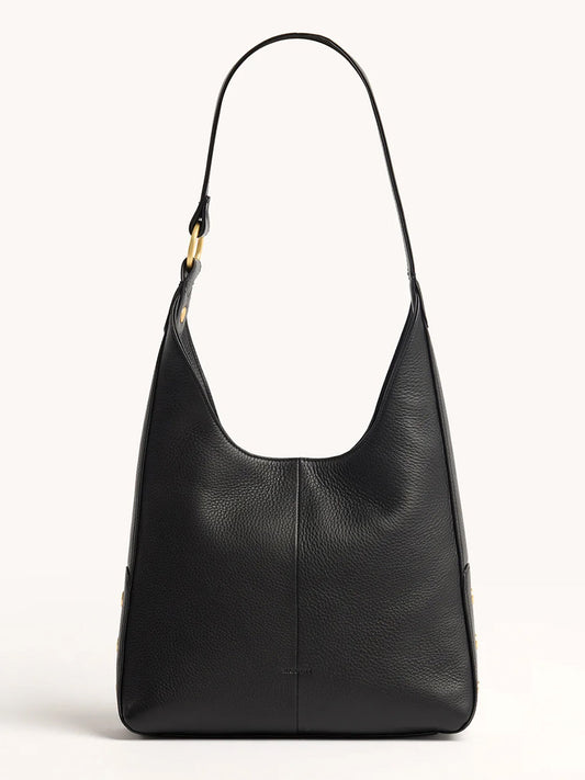 The Hammitt Los Angeles Tim Med Hobo in Black/Brushed Gold is a black pebbled leather bag with a wide strap, brushed gold hardware, a minimalist design, and magnetic closure, shown against a plain light background.