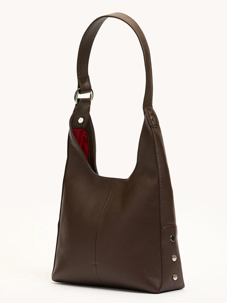 The Hammitt Los Angeles Tim Med Hobo in Espresso Pebble/Silver features dark espresso brown pebble leather, a wide strap, silver side studs, and a partially visible red fabric lining—crafted in signature Hammitt style.