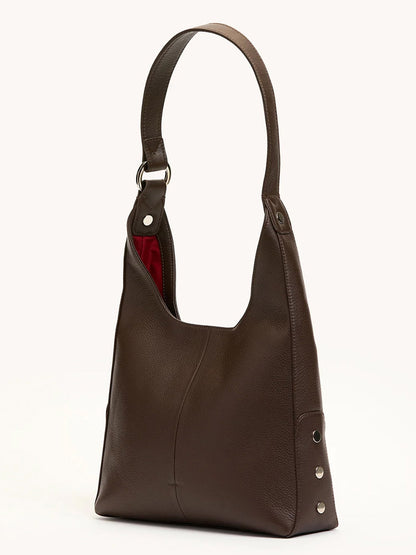 The Hammitt Los Angeles Tim Med Hobo in Espresso Pebble/Silver features dark espresso brown pebble leather, a wide strap, silver side studs, and a partially visible red fabric lining—crafted in signature Hammitt style.