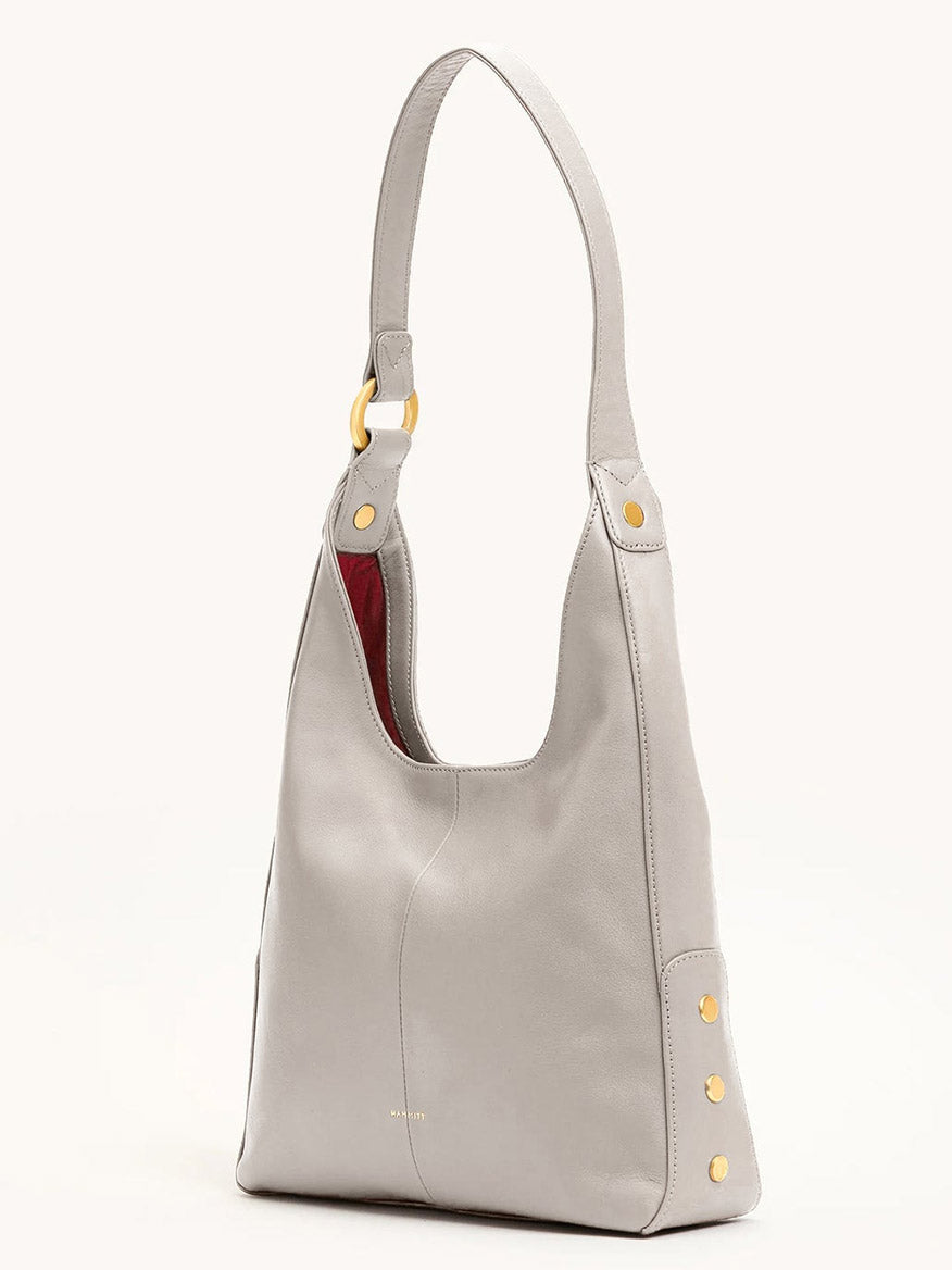 The Hammitt Los Angeles Tim Med Hobo in Stormy/Brushed Gold is a chic pebble leather shoulder bag with gold accents, perfect for elevating any outfit.