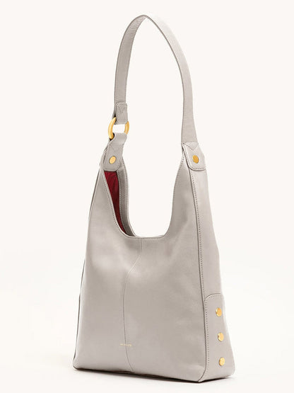 The Hammitt Los Angeles Tim Med Hobo in Stormy/Brushed Gold is a chic pebble leather shoulder bag with gold accents, perfect for elevating any outfit.