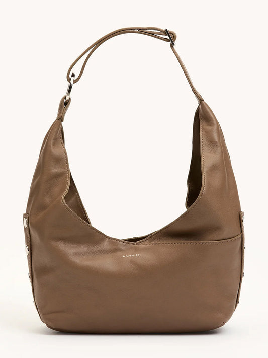 The Hammitt Los Angeles Tom Zip Medium in Dune/Silver is a taupe leather hobo bag with a wide adjustable shoulder strap, silver hardware, zippered main compartment, and minimalist design.