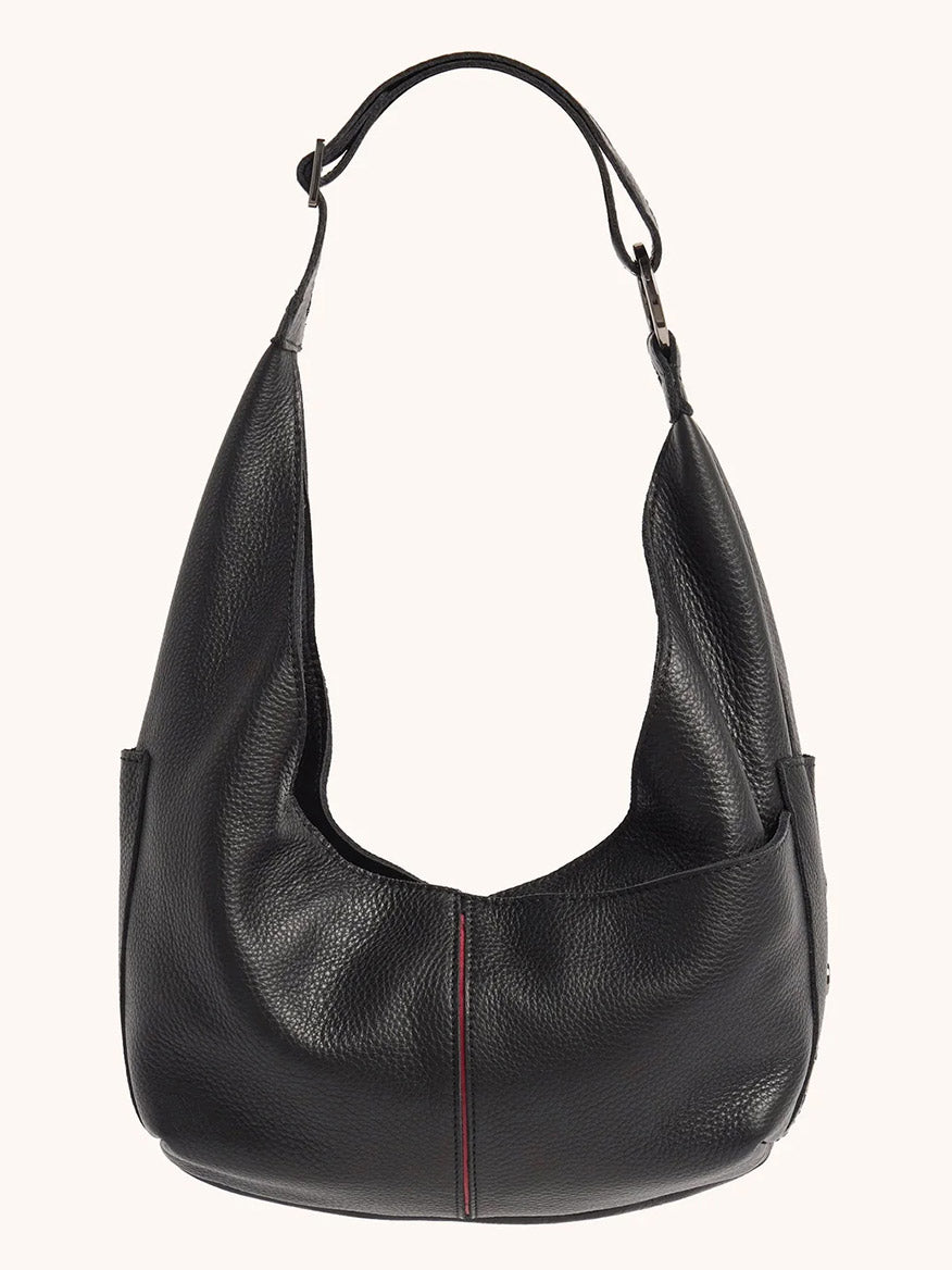 The Hammitt Los Angeles Tom Zip Medium in Black/Gunmetal is a black pebbled leather hobo bag with a wide adjustable shoulder strap, a slouchy shape, and subtle vertical red stitching down the front center.