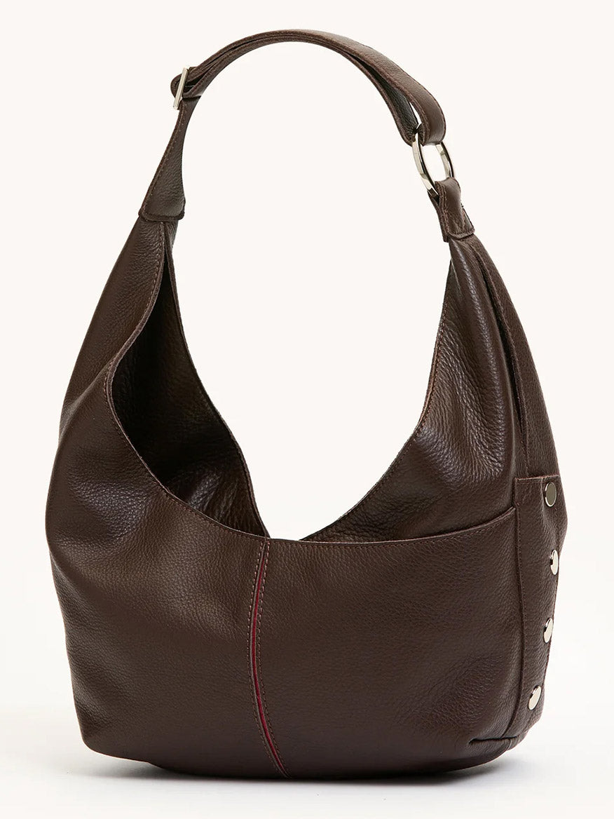 The Hammitt Los Angeles Tom Zip Medium in Espresso Pebble/Silver, a shoulder bag with a wide strap, silver hardware, and visible red front stitching, stands upright on a neutral background.