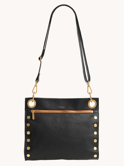 The Hammitt Los Angeles Tony Large Crossbody Bag in North End features black leather, gold-tone hardware with large grommets and side studs, an adjustable strap, and a front zip pocket, shown against a plain background.