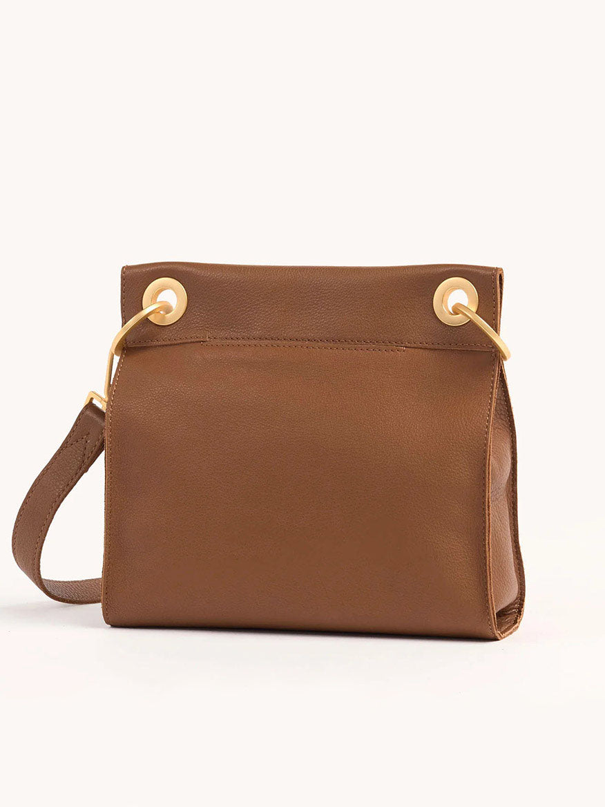 The Hammitt Los Angeles Tony Medium Crossbody Bag in Mahogany Pebble features elegant brown pebbled leather, a folded top closure, gold grommets, and an adjustable crossbody strap for versatile wear.