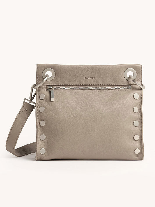 The Hammitt Los Angeles Tony Medium Crossbody Bag in Pewter Pebble is crafted from soft pebbled leather and features silver studs, a front zipper pocket, and a matching adjustable strap.