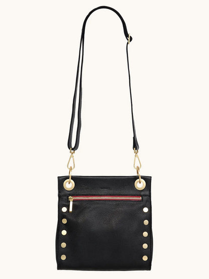 The Hammitt Los Angeles Tony Medium Crossbody Bag in Black/Brushed Gold/Red Zip features gold studs, a front pocket with a red zip, and an adjustable strap—ideal as your new everyday crossbody.