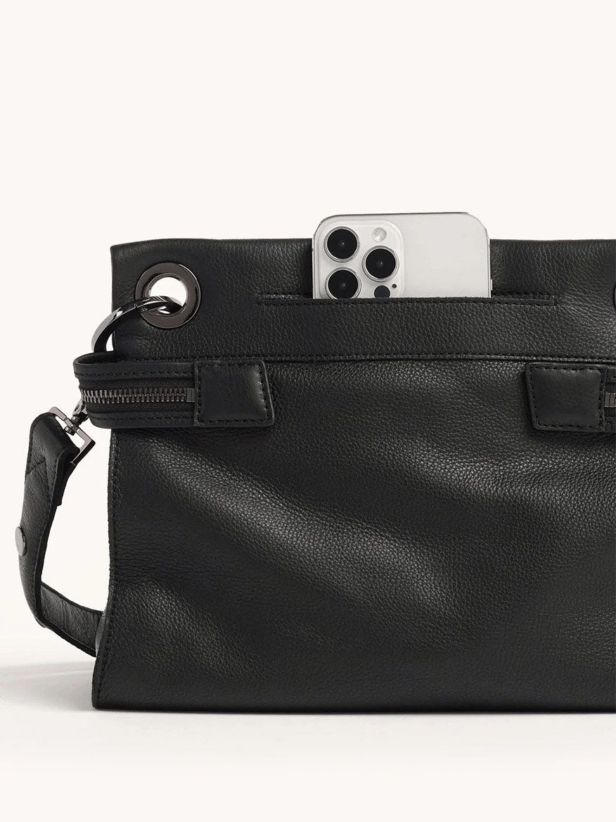 The Hammitt Los Angeles Tony Signature Medium Crossbody in Black & Gunmetal, crafted from pebbled leather with grommets, boasts a smartphone-friendly front pocket and an adjustable strap for versatile wear.