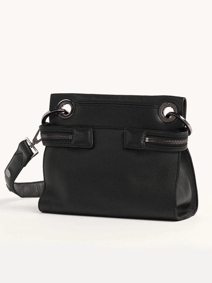 The Hammitt Los Angeles Tony Signature Small Crossbody in Black is a pebbled leather bag with silver grommets and zippers, featuring an adjustable strap for versatility.