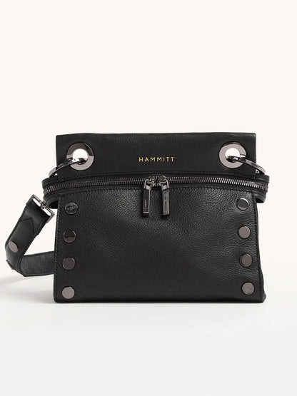 The Hammitt Los Angeles Tony Signature Small Crossbody in Black is a stylish accessory with black pebbled leather, silver hardware and studs, dual front zippers, and an adjustable strap attached with large silver rings, showcasing the HAMMITT brand for a blend of functionality and fashion.