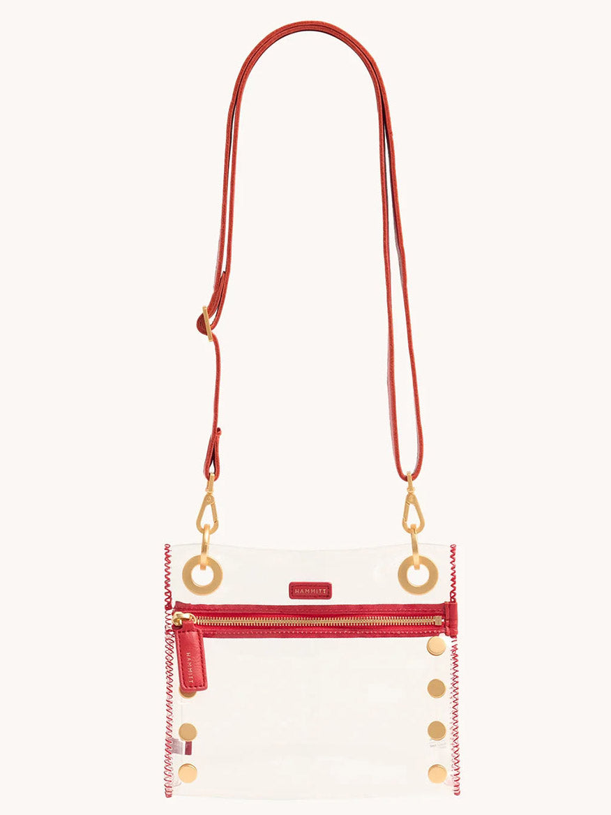 The Hammitt Los Angeles Tony Small Crossbody Bag in Clear Poppy Red features a red leather strap, accents, front zip pocket, gold-tone hardware, and an adjustable crossbody strap for versatility. Perfectly stadium-approved and chic.