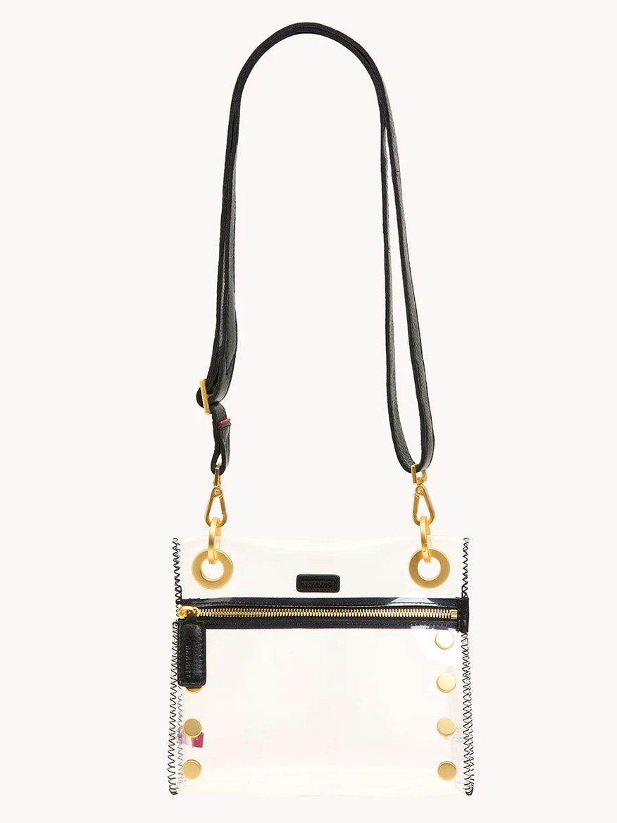 The Hammitt Los Angeles Tony Small Crossbody Bag in Clear Black/Brushed Gold is a stadium-approved clear bag featuring black leather trim, gold hardware, front zipper, gold side studs, and an adjustable crossbody strap for style and comfort.