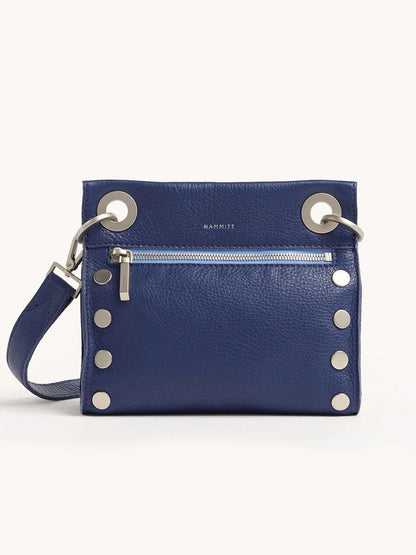 The Hammitt Los Angeles Tony Small Crossbody Bag in Jazz Blues is a blue pebbled leather handbag featuring a silver zipper, circular metal accents, and an adjustable strap perfect for crossbody wear.