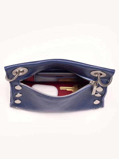 Top view of the Hammitt Los Angeles Tony Small Crossbody Bag in Jazz Blues, showcasing its open design with a white card and brass key inside.