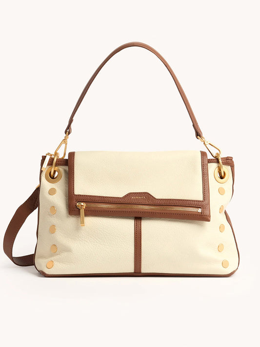 The Hammitt Los Angeles VIP Grand in Courtyard Cream is a cream and brown leather handbag with a top handle, front zipper pocket, gold hardware, and side gold studs. Wear it as a crossbody bag for versatile style inspired by classic Hammitt designs.