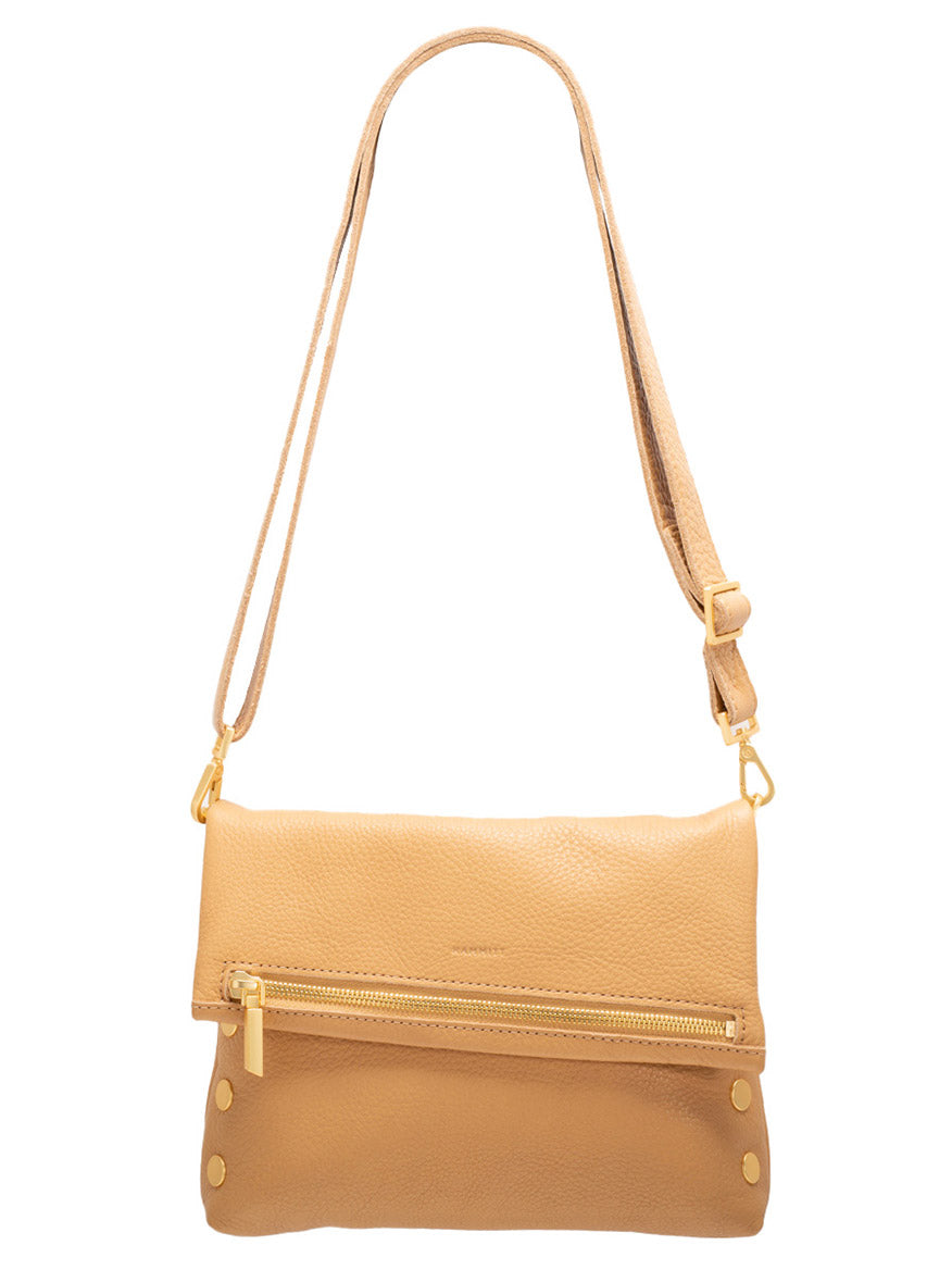 The Hammitt Los Angeles VIP Medium Clutch in Toast Tan features a fold-over flap, gold zipper, and a removable crossbody strap for versatile style.