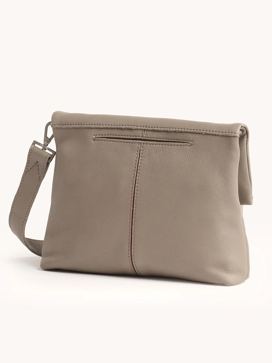 The Hammitt Los Angeles VIP Medium Clutch in Pewter Pebble features a visible center seam, a matching wrist strap on the left, and a removable crossbody strap for versatile styling.